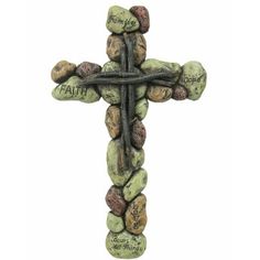 a cross made out of rocks with the words faith on it