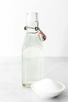 a glass bottle with a spoon next to it