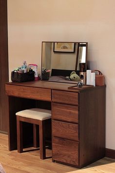 a wooden desk with a mirror and stool