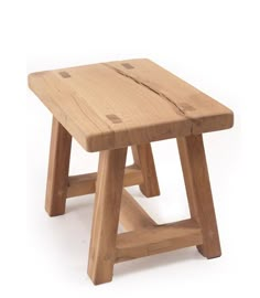 a small wooden stool sitting on top of a white floor