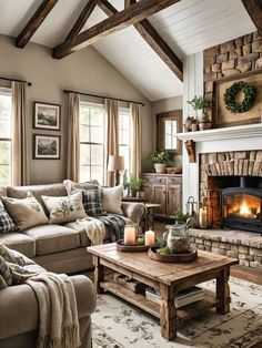 a living room filled with furniture and a fire place in front of a fireplace covered in blankets