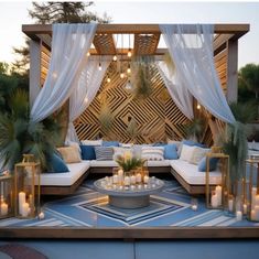 an outdoor living area with couches and candles