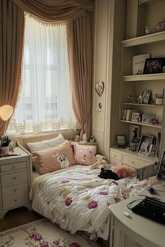 a bedroom with a bed, desk and computer on the table in front of a window