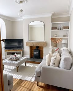 a living room filled with furniture and a fire place