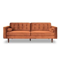 an orange couch sitting on top of a white floor