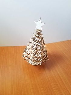 a small wooden christmas tree sitting on top of a table