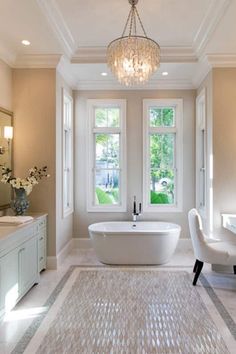 a large bathroom with two sinks and a bathtub in the middle of the room