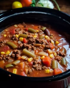 a close up of a bowl of soup with meat and vegetables