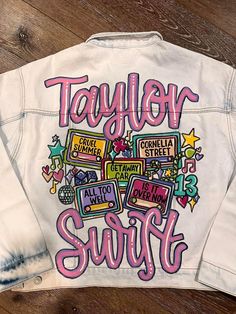 a white jean jacket with the words taylor swift on it and colorful letters in different colors