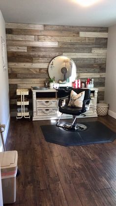 a room with a chair, desk and mirror