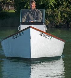 a man driving a boat in the water