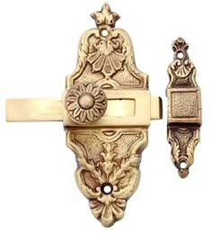 an ornate door handle and latch on a white background