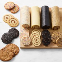 an assortment of cookies and pastries on a cutting board