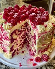 a white cake with raspberries and cream frosting