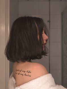 a woman with a tattoo on her shoulder