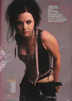 a woman with black hair and piercings on her chest posing for a magazine cover