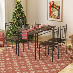 a dining room table and chairs with a christmas tree in the background