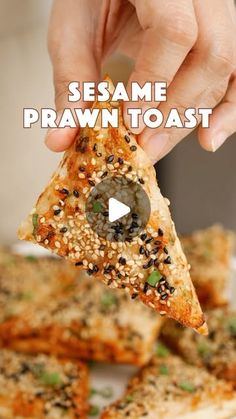 someone holding a piece of pizza with sesame sprinkled on it and the text sesame praw toast