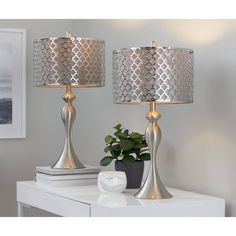 two lamps sitting on top of a white table