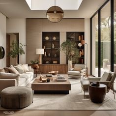 a living room filled with lots of furniture next to a tall glass window covered wall