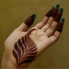 a woman's hand with a leaf painted on it