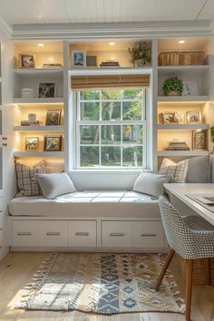 a white window seat sitting under a window in a living room next to a desk