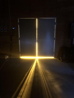 an open door in the dark with light coming from it's sides and shining on the floor