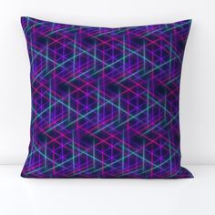 a purple and blue pillow with an abstract design