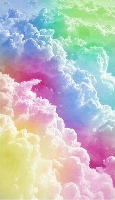 the sky is full of clouds and rainbow colors