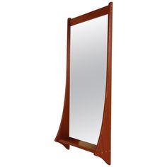 a mirror that is sitting on top of a wooden shelf with an upside down section