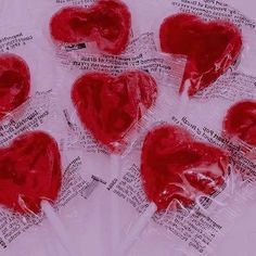 six heart shaped lollipops wrapped in cellophane