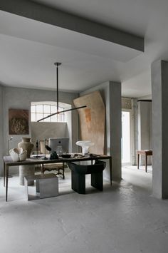 an office with concrete walls and white floors