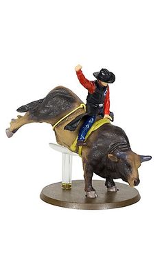 a figurine of a cowboy riding a bull