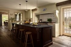 a large kitchen with an island in the middle and lots of stools around it