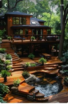 an outdoor deck with steps leading up to a large house in the woods, surrounded by greenery and trees