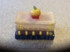 an apple is sitting on top of two books that are stacked on top of each other