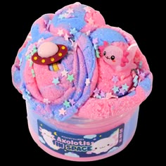 a pink and blue bath toy in a plastic container with stars on it's sides