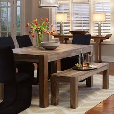 a dining room table with chairs and a bench