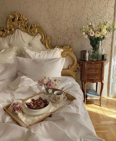 a tray with food on top of a bed