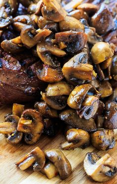 mushrooms and steak on a cutting board ready to be cooked