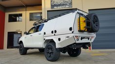 a white truck parked in front of a building