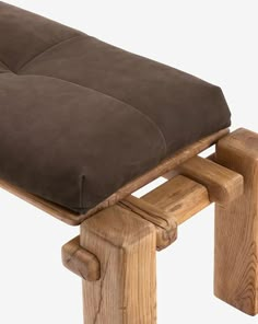 a wooden bench with a cushion on it