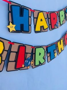 a happy birthday banner hanging on a wall