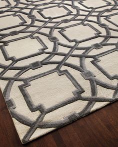 a white rug with black and grey designs on it