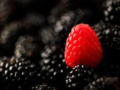 a close up view of blackberries and raspberries