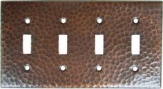 a metal switch plate cover with four plates on it and one is in the middle