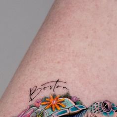 a close up of a person's leg with a tattoo on it and an image of a turtle