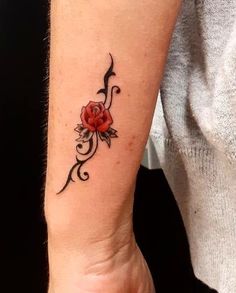 a woman's arm with a rose tattoo on it