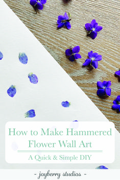 purple flowers on top of a wooden table with text overlay that reads how to make hammered flower wall art