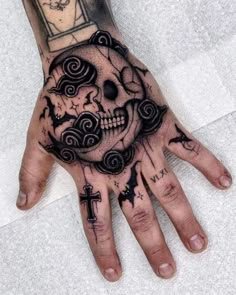 a person's hand with a clock on it and a skull in the middle